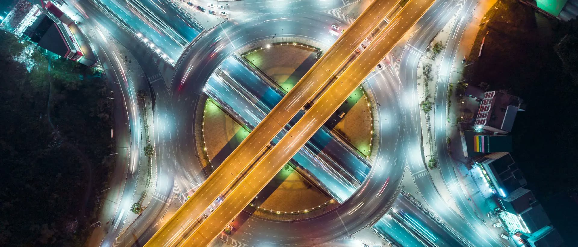 Night aerial view of a motorway interchange, roads crossing a roundabout